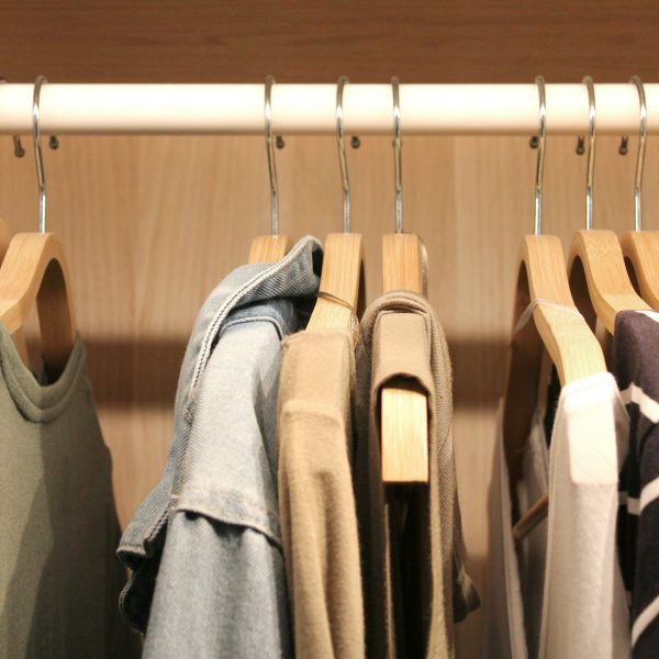 Clothes on coat hangers in a wardrobe